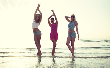 Image showing happy female friends dancing on beach