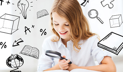 Image showing girl reading book with magnifier at school