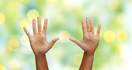 Image showing african hands making high five over green lights