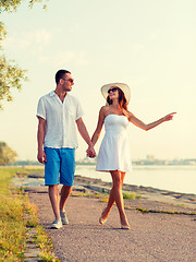 Image showing smiling couple walking outdoors