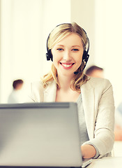 Image showing helpline operator with headphones in call centre