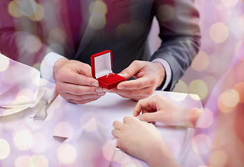 Image showing excited young woman and boyfriend giving her ring