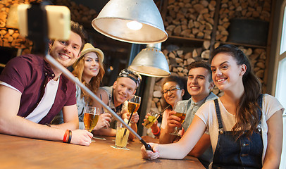 Image showing friends with smartphone on selfie stick at bar