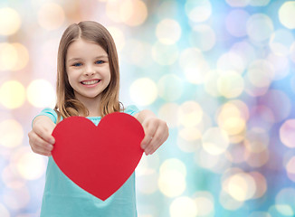 Image showing smiling little girl giving red heart