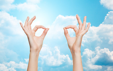 Image showing woman hands showing ok sign over blue sky