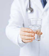 Image showing doctor hands giving glass of water