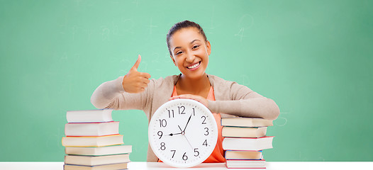 Image showing african student girl with books and clock