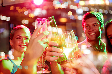 Image showing smiling friends with wine glasses and beer in club