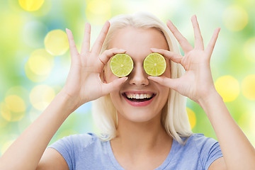 Image showing happy woman having fun covering eyes with lime