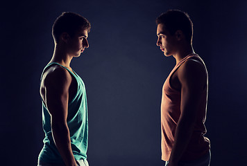 Image showing young men looking to each other