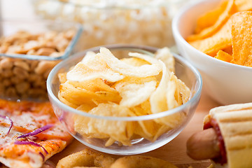 Image showing close up of crunchy potato crisps in glass bowl