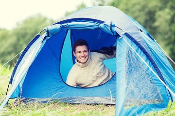 Image showing smiling male tourist in tent