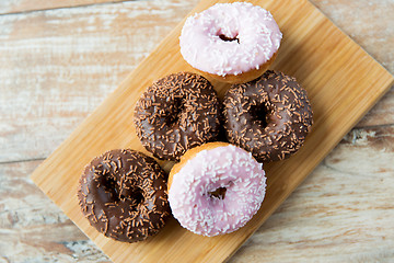 Image showing close up of glazed donuts pile on table