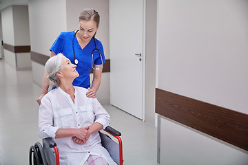 Image showing nurse with senior woman in wheelchair at hospital