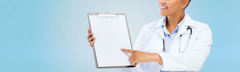 Image showing close up of smiling female doctor with clipboard