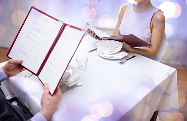 Image showing close up of couple with menu at restaurant