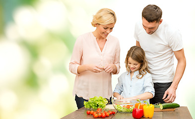 Image showing happy family cooking vegetable salad for dinner