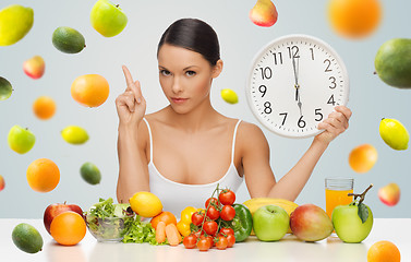 Image showing woman with healthy food and clock warning