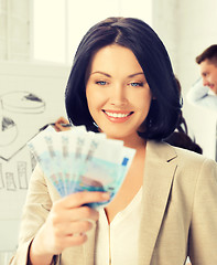 Image showing happy businesswoman with cash money in office