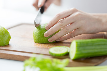 Image showing close up of woman hands chopping green vegetables