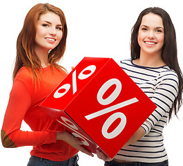 Image showing two smiling teenage girl with percent sign on box