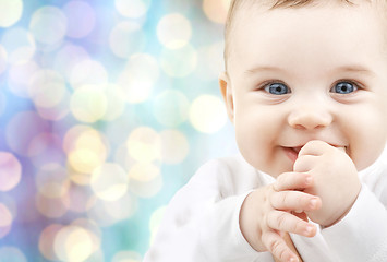 Image showing happy baby over blue holidays lights background