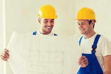 Image showing group of builders with blueprint