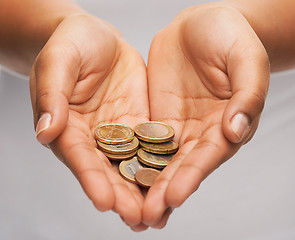 Image showing womans cupped hands showing euro coins