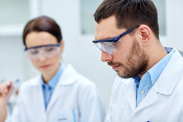 Image showing close up of young scientists at laboratory