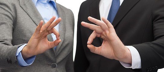 Image showing businessman and businesswoman showing ok sign