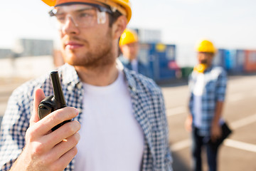 Image showing close up of builder in hardhat with walkie talkie