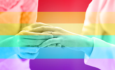 Image showing close up of lesbian couple hands with wedding ring