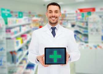 Image showing smiling male doctor with tablet pc at drugstore