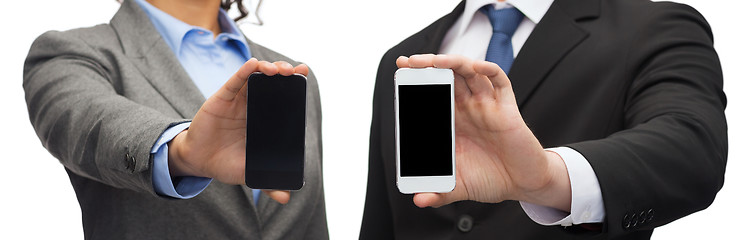 Image showing businessman and businesswoman with smartphones