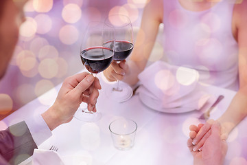 Image showing young couple with glasses of wine at restaurant