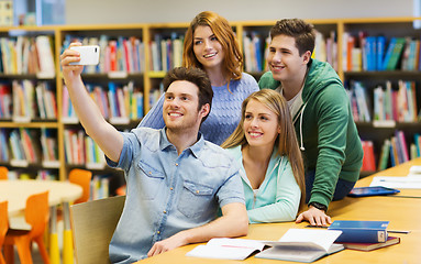 Image showing students with smartphone taking selfie in library