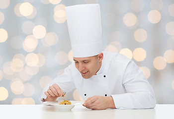 Image showing happy male chef cook decorating dish