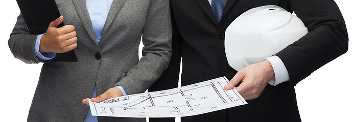 Image showing businesspeople with blueprint and helmet