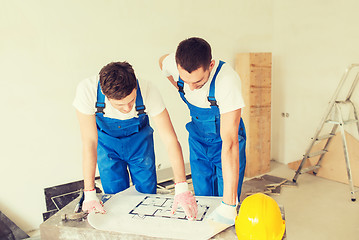 Image showing group of builders with blueprint