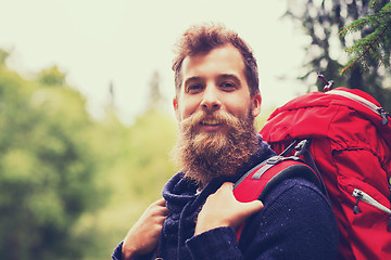 Image showing smiling man with beard and backpack hiking