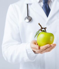 Image showing male doctor with green apple