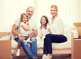 Image showing smiling parents and two little girls at new home