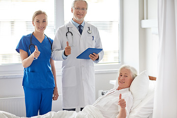 Image showing doctor and nurse visiting senior woman at hospital