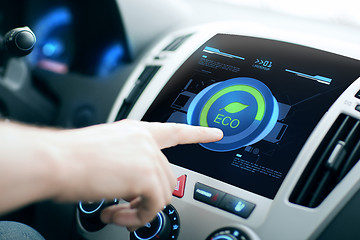 Image showing male hand setting car eco system mode on screen