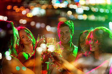 Image showing smiling friends with glasses of champagne in club