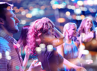 Image showing smiling friends dancing in club