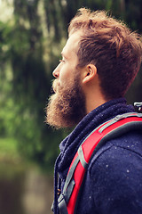 Image showing smiling man with beard and backpack hiking