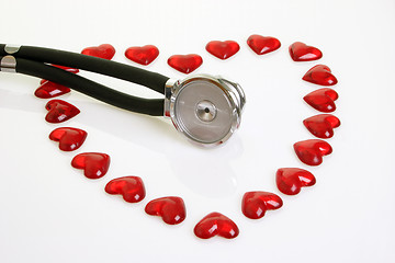 Image showing Stethoscope with red plastic hearts