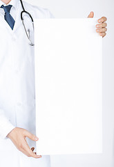 Image showing doctor holding blank white banner