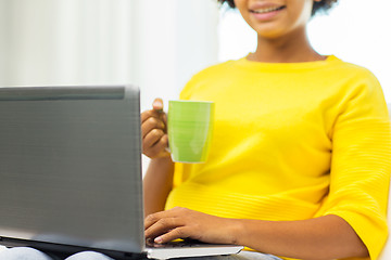 Image showing happy african american woman with laptop at home